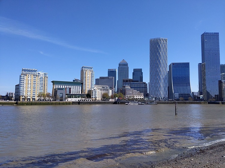 Photo of the modern Isle of Dogs from across the river, tall office tower blocks and lower apartment blocks