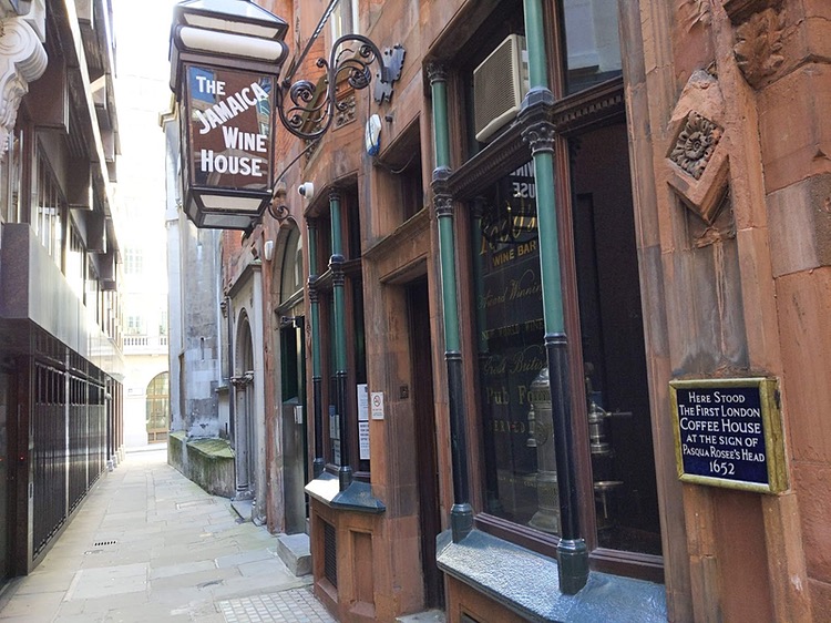 Photo of a narrow alleyway with a pub on the right, hanging outside of which is a large lantern with 'The Jamaica Wine House' written on it